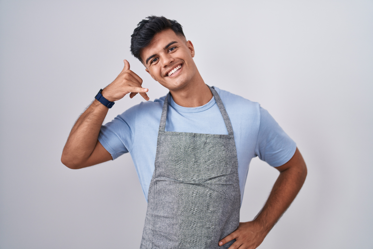 Young Man Shopkeeper Gesturing Phone Call 1200X800