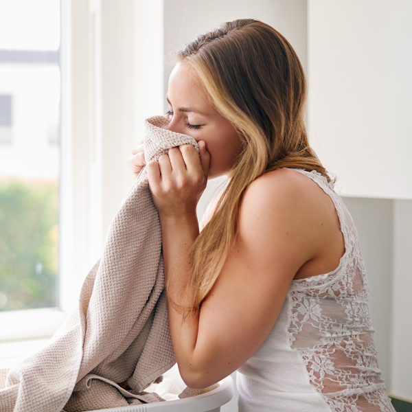 Woman Smelling Fresh Clean Beige Towel 600X600