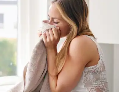 Woman Smelling Fresh Clean Beige Towel 600X600
