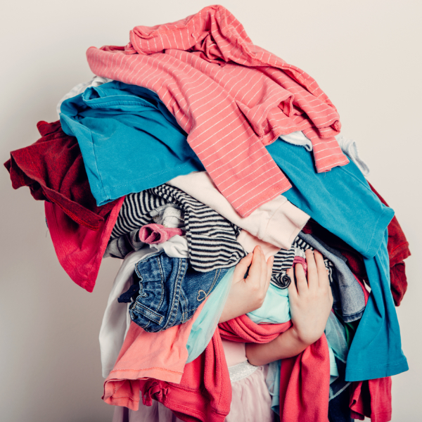 Girl Holding A Lot Of Laundry 600X600